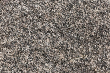 Texture of rough torn edge of gray granite stone