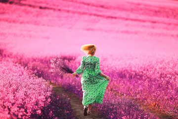 girl in a field of lilac flowers in lavender colors, violet and pink landscape, happy and harmony