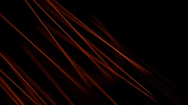 Glass bulb of a lamp. Extremely close view. Macro. Tungsten filaments glow with a warm orange light. The spiral vibrates with electricity.