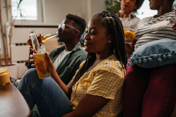 Friends drinking beer and having fun in the living room
