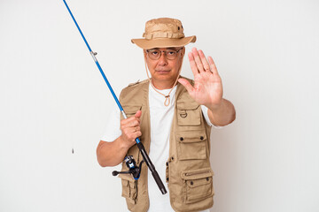 Senior american fisherman holding rod isolated on white background standing with outstretched hand showing stop sign, preventing you.