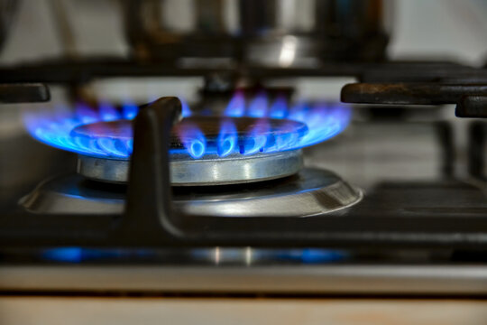 Gas Cooking. The Blue Flames Of The Gas Heat The Food In The Container.