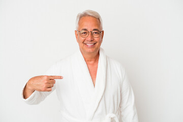 Senior american man wearing bathrobe isolated on white background person pointing by hand to a shirt copy space, proud and confident