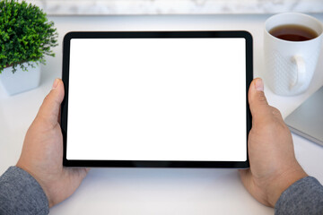 male hands holding computer tablet with isolated screen in office