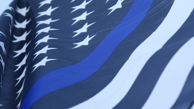 Black white american monochrome flag with blue stripe or line, police support. Solid star-spangled banner waving in wind breeze.