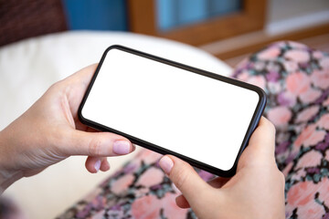 female hands hold phone horizontally with isolated screen