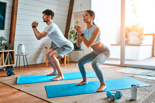 Young couple doing sports at home