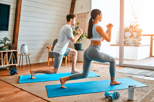 Young couple doing sports at home