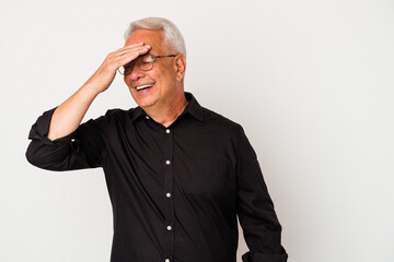 Senior american man isolated on white background covers eyes with hands, smiles broadly waiting for a surprise.