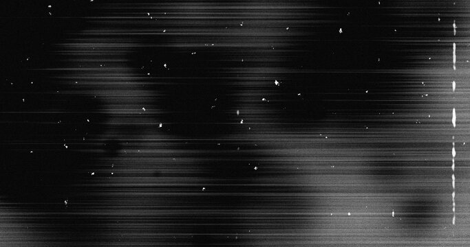 Image of multiple white specks and lines moving on seamless loop in black and white