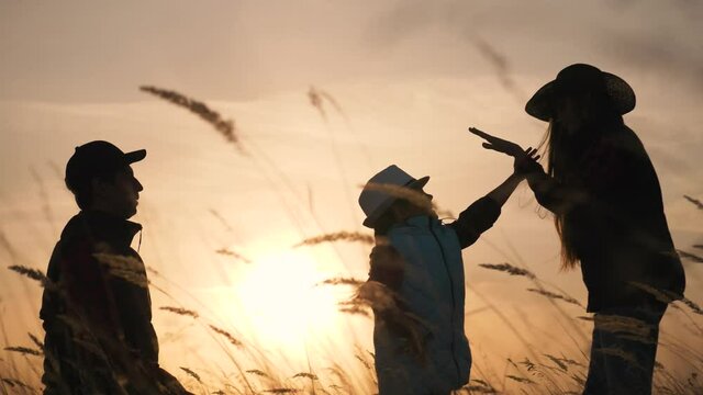 happy successful family reaches goal Family hiking in nature. Silhouette of successful people. Father day in family. Silhouette of happy father gives helping hand kid. Success of father, kid for walk.