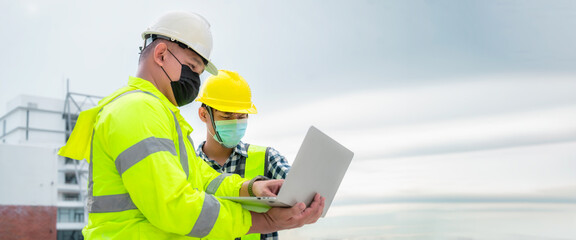 Banner : Civil engineer wearing mask inspect construction site structure and plans in laptop. Civil...