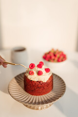 Delicious cupcakes with berries on stand over white background