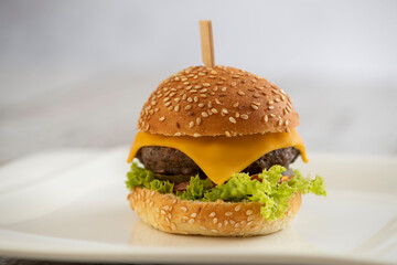 mini burger with cheese and lettuce with sticks - obrazy, fototapety, plakaty