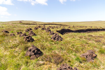 Stacks of Peat cuttings drying in the sunshine Isle of Lewis Outer Hebrides Scotland.