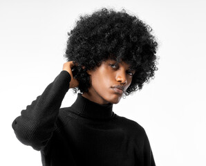 Portrait of young handsome black man touching his afro hair isolated on white background