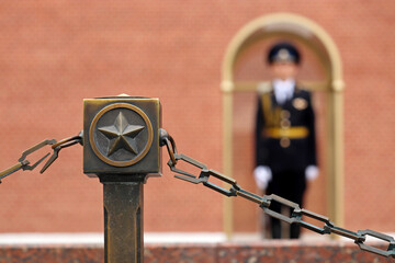 Soviet star and defocused view to russian soldier on duty near the Kremlin wall. The honor guard of...