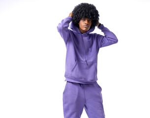 Handsome black man in tracksuit put on the hood isolated on white background