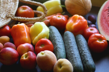 Straw bag and various seasonal fruit and vegetable. Selective focus.
