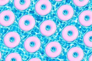 top view of pattern of pink floats on swim pool. Summer concept. 3d illustration