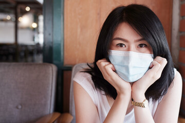 Asian woman is wearing mask prevent for covid-19 and infection corona virus or Air pollution pm 2.5. Virus outbreak in Thailand