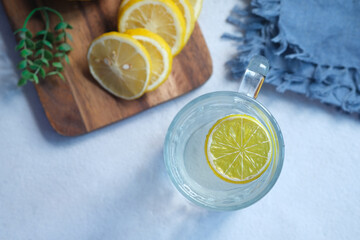 Refreshing drink with lemon on table , top view 