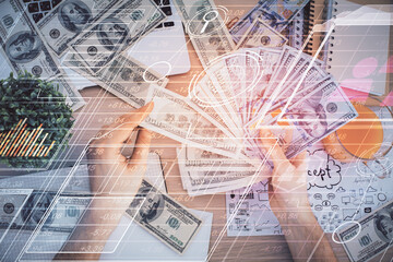 Multi exposure of technology drawing hologram and us dollars bills and man hands. Data concept