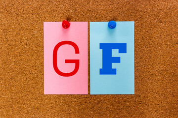 Conceptual 2 letter keyword GF (Girl Friend, Girlfriend) on multicolored stickers attached to a...