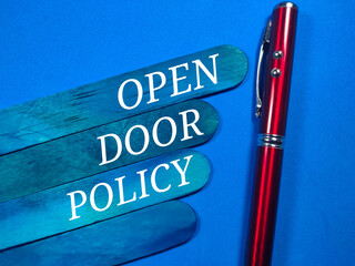 Text OPEN DOOR POLICY with pen on blue background.
