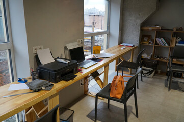 Cozy office workplace in front of the window 