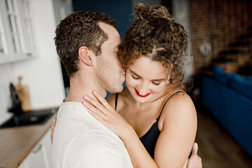 Close up view of man hugs happy woman , smiling millennial just married couple embracing in modern apartment, concept of capture happy moment, harmonic relationships, care and sincere feelings