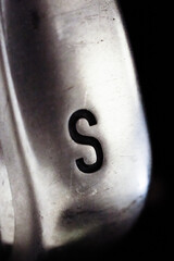 Letter "s" engraved on a piece of metal