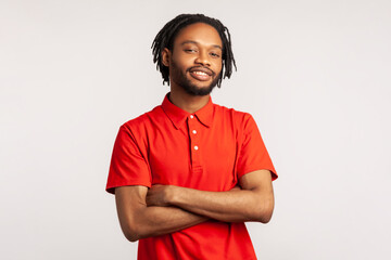 Young adult bearded man with dreadlocks wearing red casual T-shirt posing with confident facial...