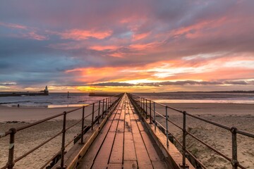 A glorious morning at Blyth beach, with a beautiful sunrise over the old wooden Pier stretching out...