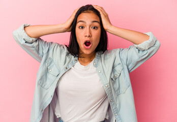 Young Venezuelan woman isolated on pink background surprised and shocked.