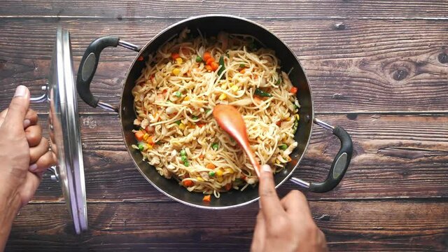  pasta in a pan on black background.