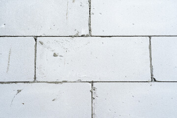 Frontal view of a wall made of old bricks of different sizes