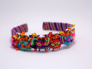 
Headband with handmade ornaments of coyas motifs. Crafts from the north of Argentina. Upper Peru, Bolivia, Northern Argentina. People with indigenous coya clothing. Colorful traditional crafts.