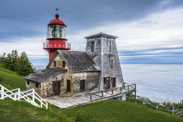 Fototapeta na wymiar View on the beautiful Pointe a la Renommée Lighthouse covered with shingles, one of the most famous lighthouse of Gaspesie, in Quebec (Canada) 