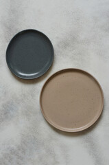 eco friendly handmade ceramic tableware top view with copy space for text and design, clay empty plate flat lay, cutlery and table setting, minimalism and ceramics tableware