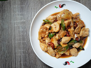 White Plate With Yummy Szechuan Kungpao Chicken and Vegetables. Selective Focus