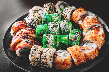 set of sushi roll with salmon, avocado, cream cheese, cucumber, rice, tuna