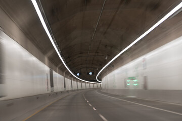 motion car go through illuminated way under ground. light trails. transportation background.