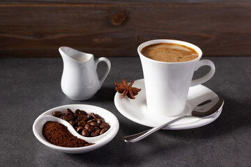 Cup of coffee and beans with ingredient on table background texture. Break coffee time