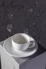 Empty cup coffee on concrete grey cube as  background texture.  Abstract concept of break coffee time