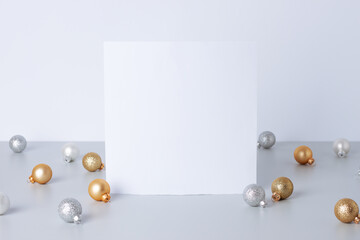 Christmas white and grey minimal background with mock up greetings card and ball. Close up, copy space © luckyshoe