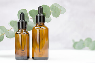 Two bottles with eucalyptus essential oil close-up. Blank for advertising eucalyptus oil. Organic...