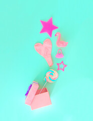 Pink gift box from which women's accessories come out. Women's gifts.