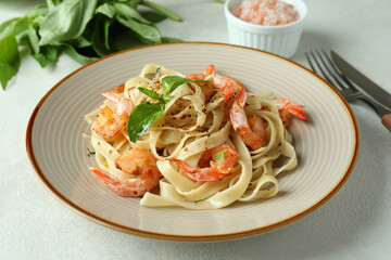 Concept of tasty eating with shrimp pasta on white textured table