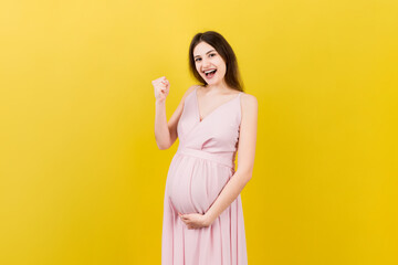 Young beautiful pregnant woman on isolated colored background celebrating surprised and amazed for success with arms raised and open eyes. Winner concept